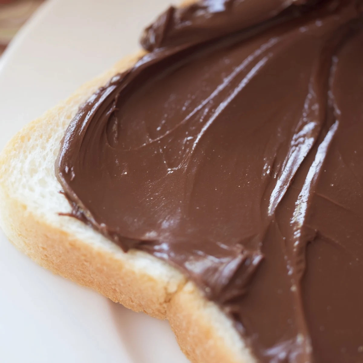 Freshly spread chocolate on toasted bread, sprinkled with sea salt for an easy breakfast treat.