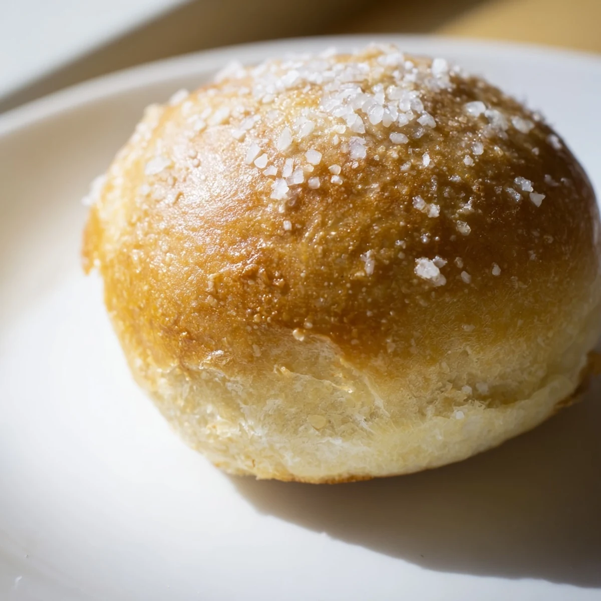 Freshly baked Savory Roll with Butter, golden-brown and brushed with melted butter, served warm on a rustic wooden board.