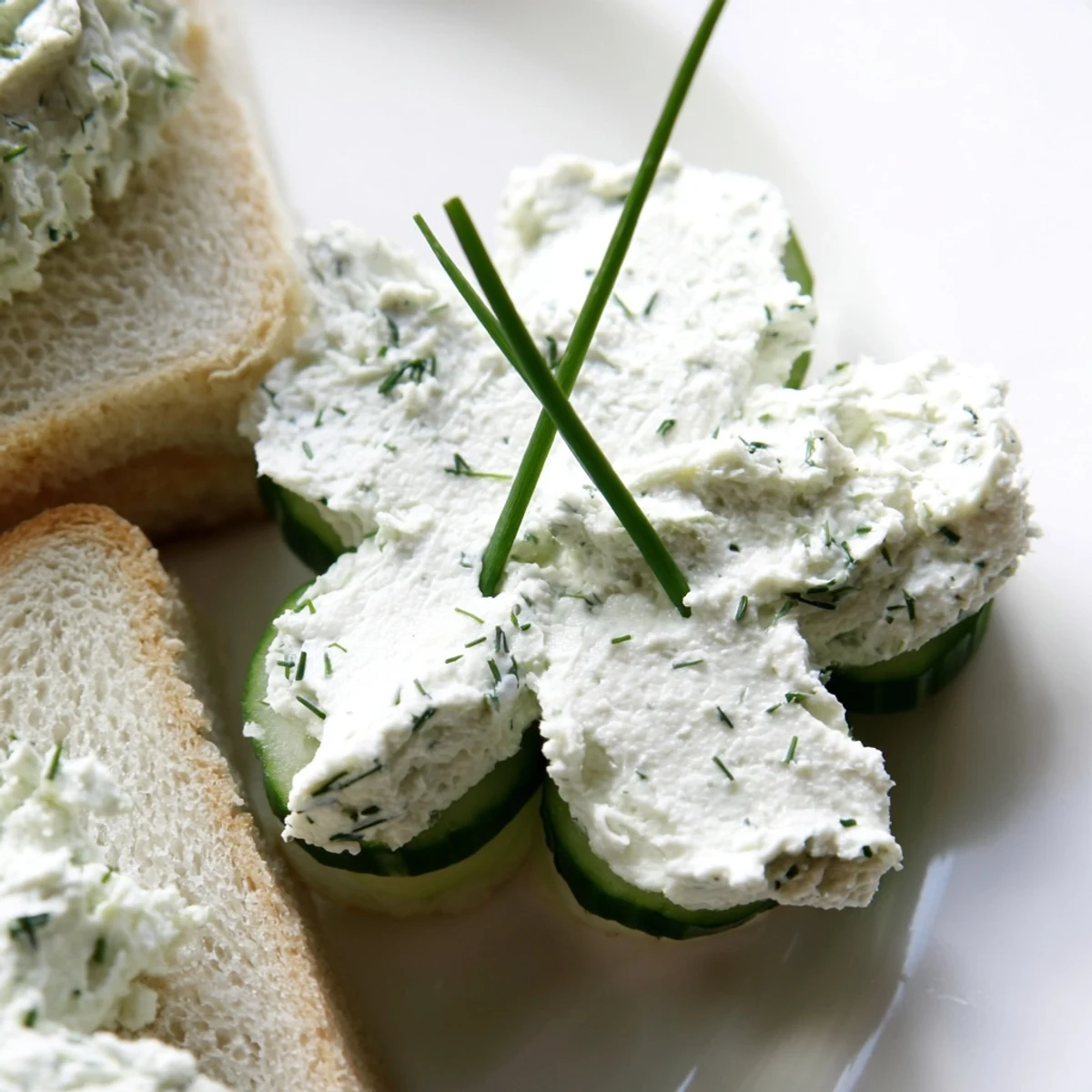 Layered on a wooden board, these easy vegetarian appetizers showcase crunchy English cucumber and velvety cream cheese filling.