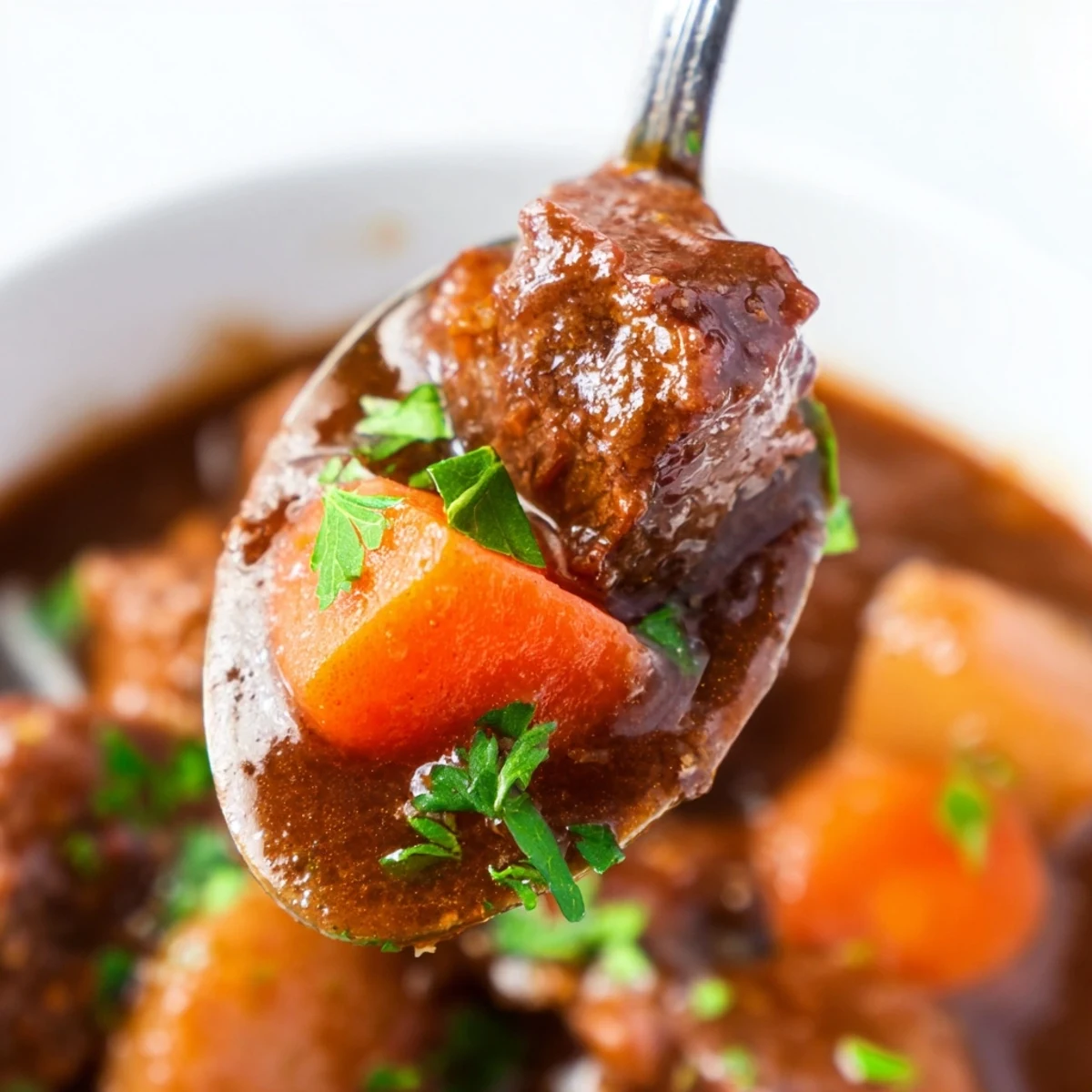 Steam rises from the slow cooker, revealing tender chunks of beef and sweet carrots in a rich, savory broth.