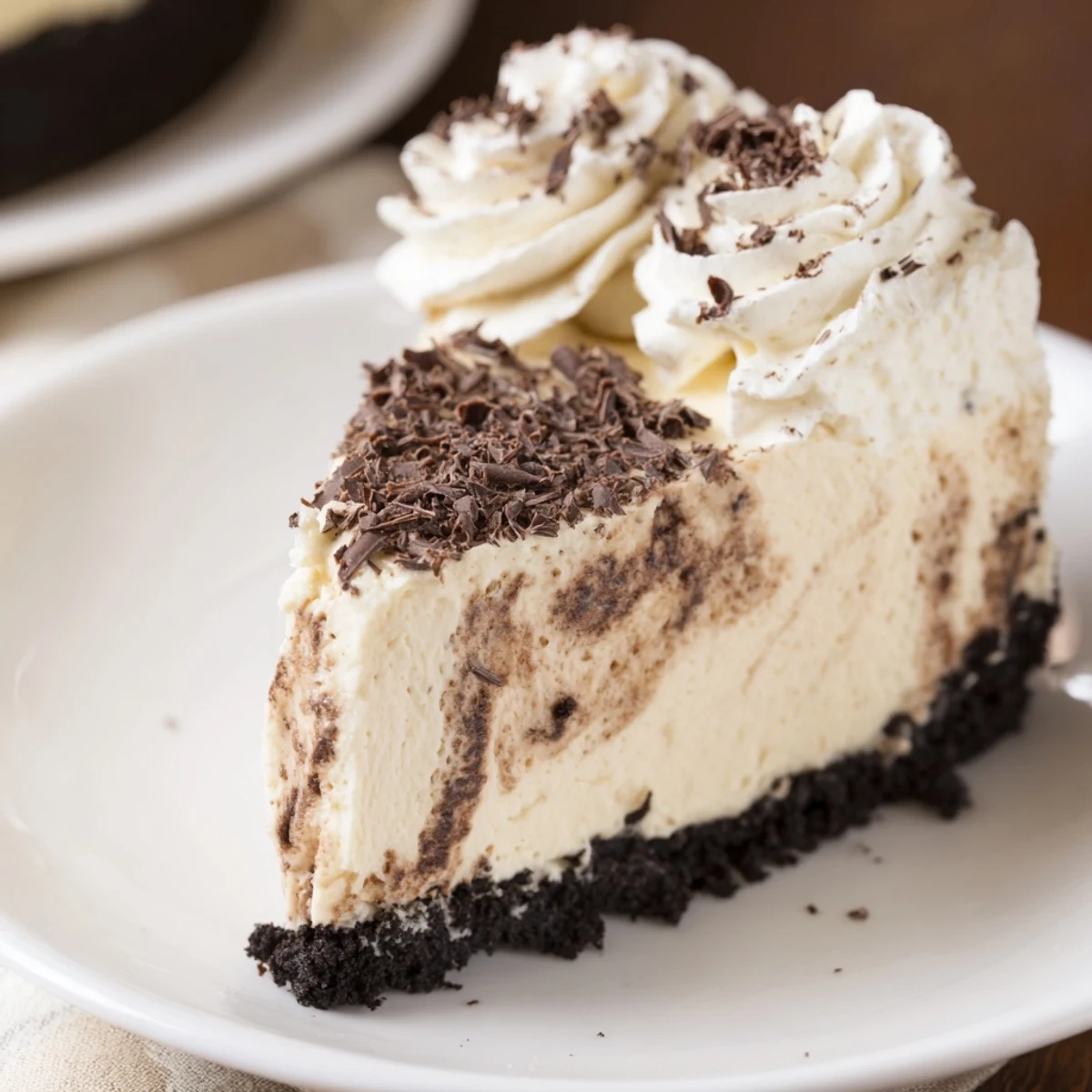Decadent Irish Cream Cheesecake garnished with cocoa powder, a perfect dessert for St. Patrick's Day celebrations.