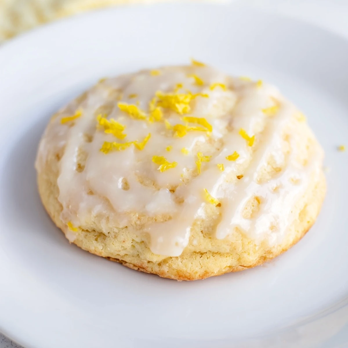 Lemon Ricotta Cookies with glaze arranged on a serving plate, perfect with tea or coffee for dessert.
