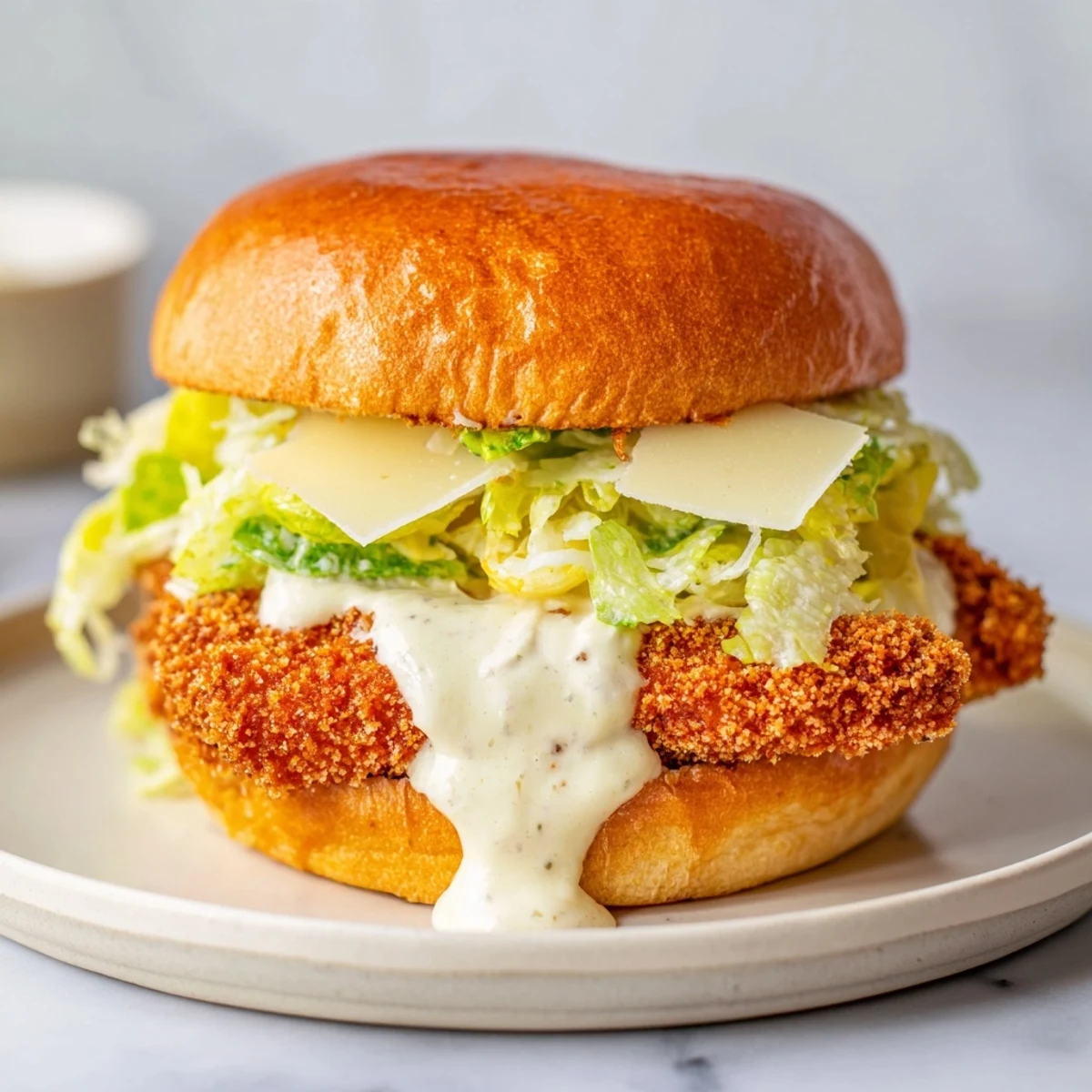 A toasted Marry Me Crispy Chicken Caesar Sandwich stacked high with crunchy chicken and fresh tomato slices, perfect for lunch.