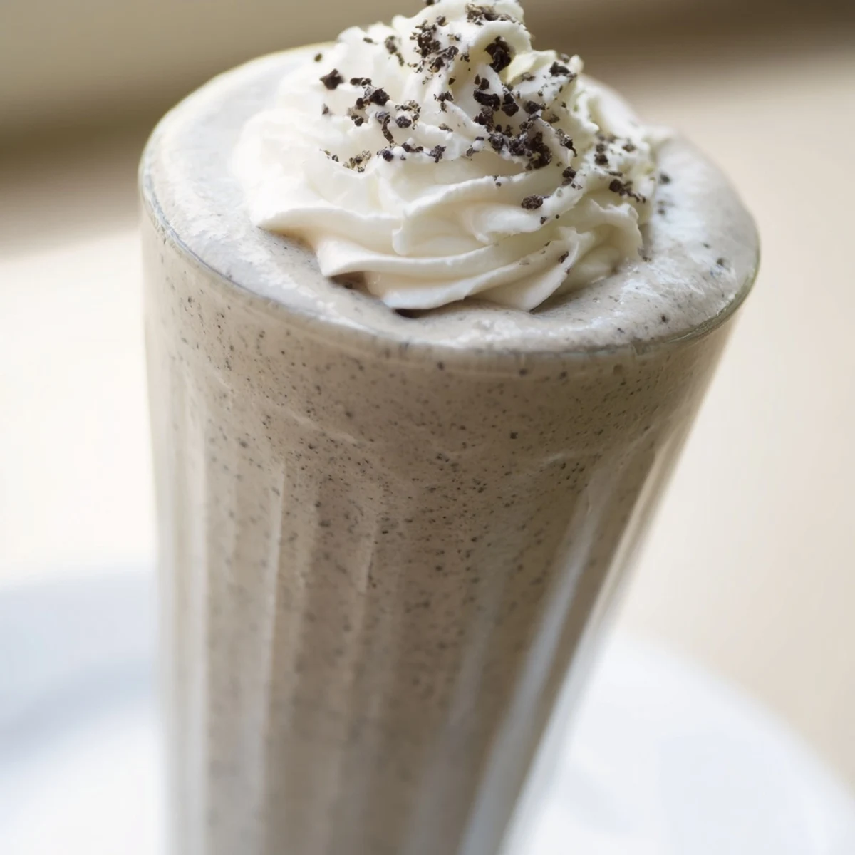 Homemade Vanilla Bean Frappuccino blending milk, cream, sugar, and ice for a frosty coffeehouse treat.