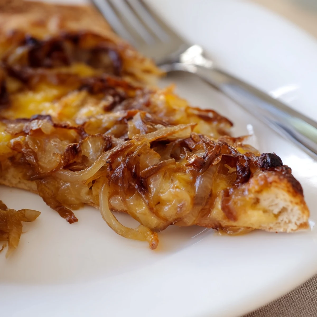 Caramelized Onion Pizza With Melty Cheese sits beside fresh arugula and a glass of wine.