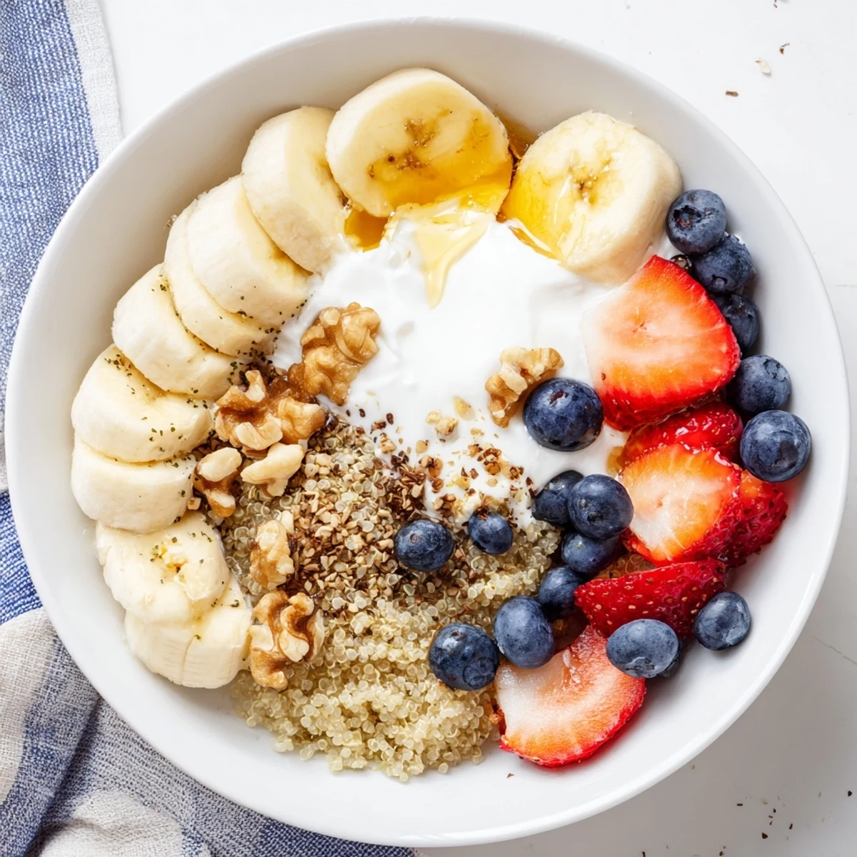 Freshly prepared Dietitians Balanced Breakfast Bowl featuring creamy yogurt, sliced bananas, mixed berries, and soft-boiled eggs for a nourishing morning meal.