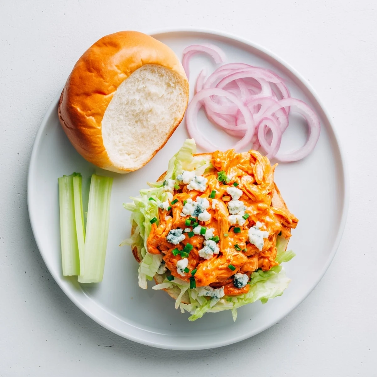 Juicy Spicy Buffalo Chicken Sliders are stacked high with creamy blue cheese and fresh lettuce on soft buns.