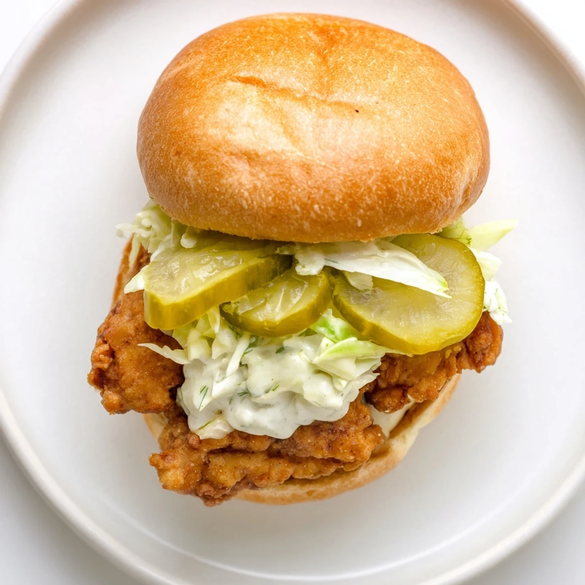 Golden crispy dill chicken sandwich topped with tangy pickles and creamy dill mayo