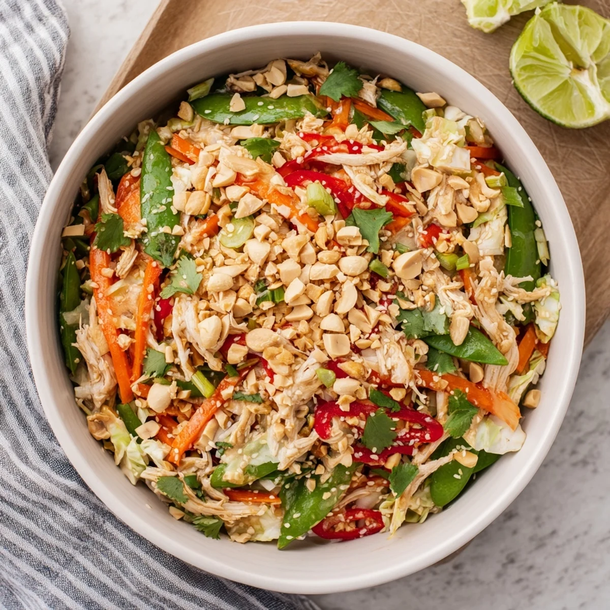 Colorful bowl of Asian chicken salad with crisp vegetables and zesty sesame-ginger dressing