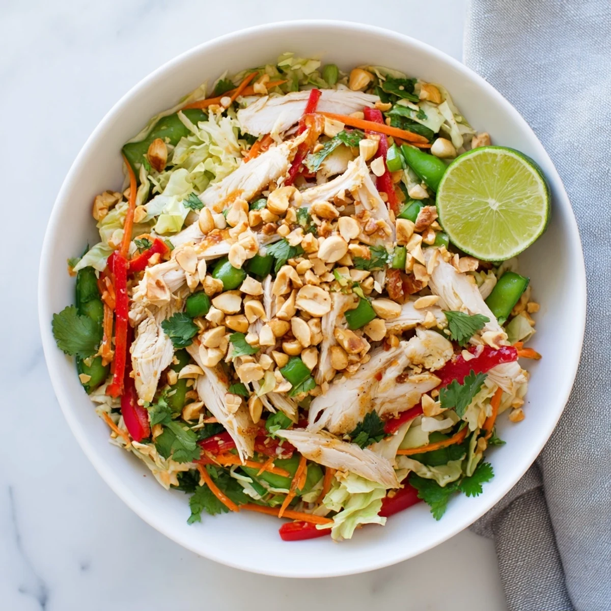 Protein-packed no cook Asian chicken salad featuring shredded chicken and vibrant crunchy vegetables