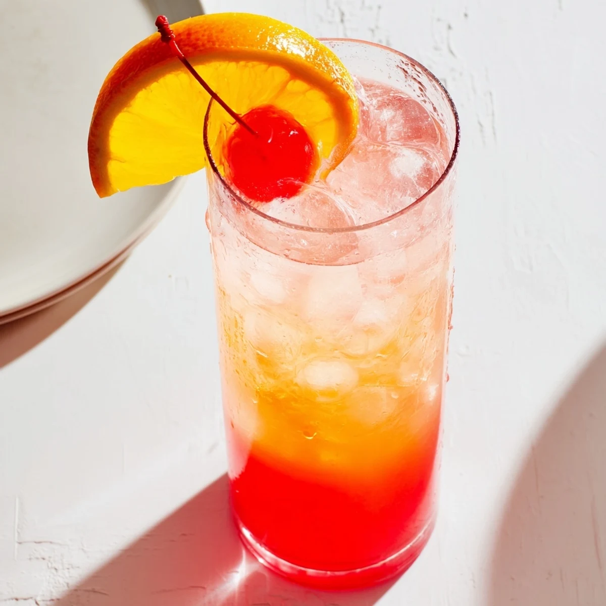 Glass of Easy Shirley Temple Drink with fizzing soda and maraschino cherry on top