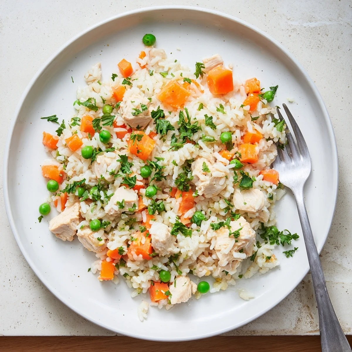Golden brown chicken pieces nestled with fluffy rice and colorful vegetables in this comforting Instant Pot chicken and rice recipe