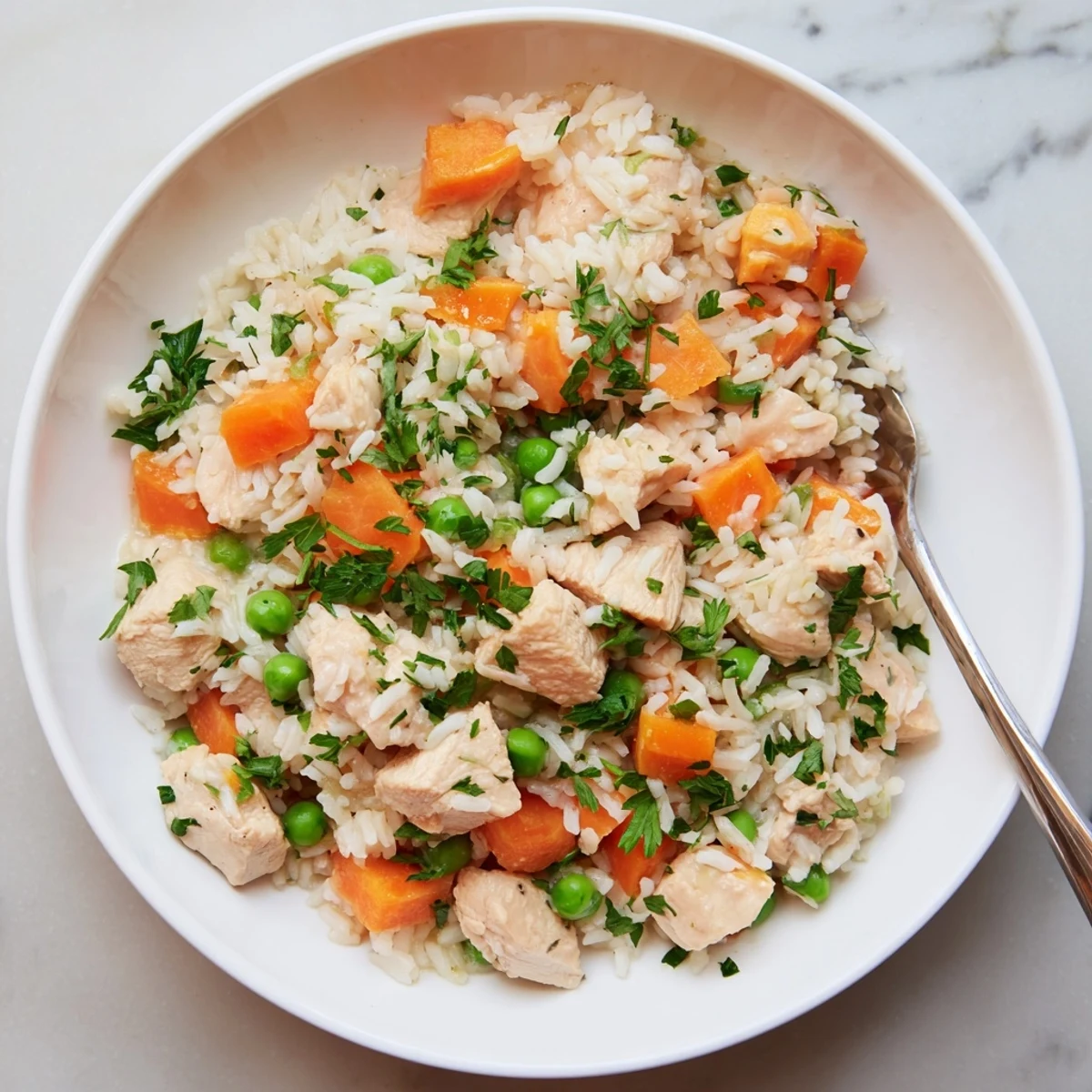 One pot meal featuring tender chicken thighs, steamed white rice, and vibrant peas ready for this easy Instant Pot chicken and rice recipe