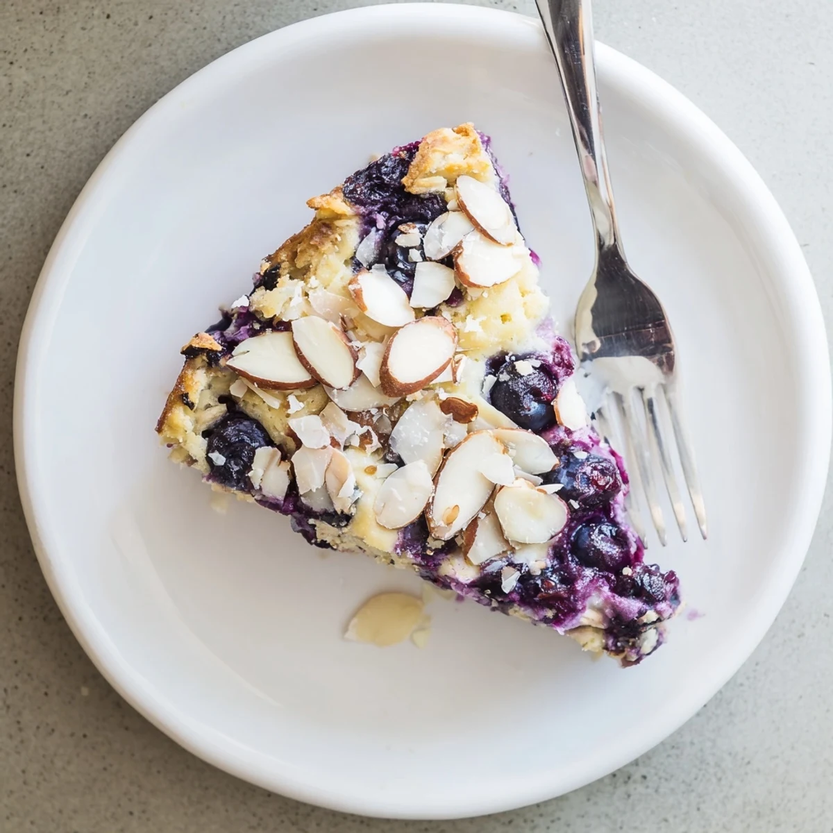 Creamy cottage cheese breakfast bake featuring juicy blueberries and tender baked oat topping
