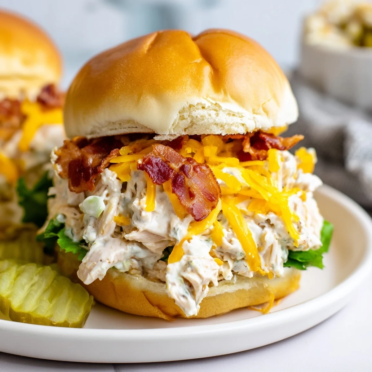 Open-faced Crack Chicken Sandwiches showing bubbly filling, crumbled bacon, optional pickle slices