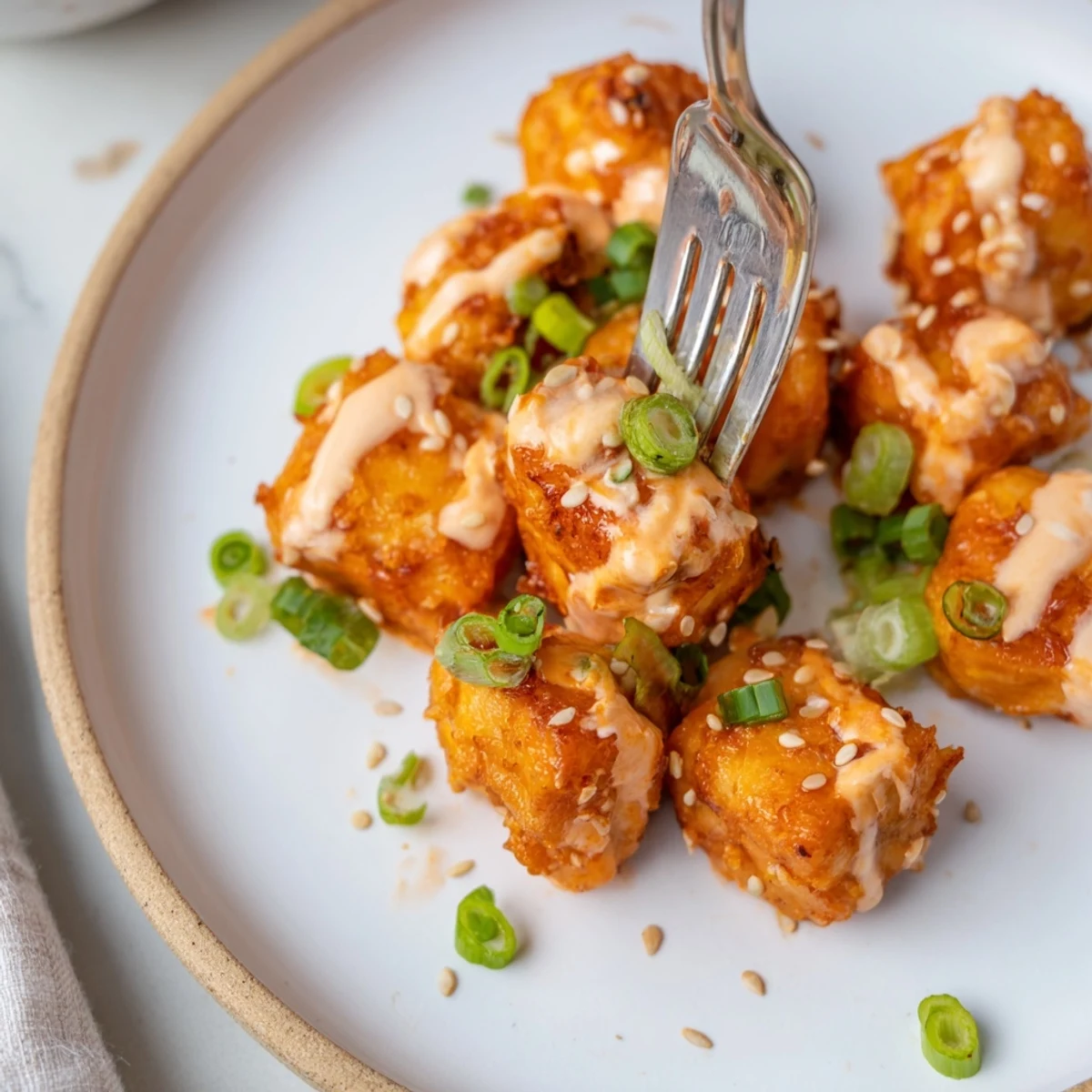 Golden Bang Bang Salmon Bites recipe glistening with sauce, perfect party appetizer.