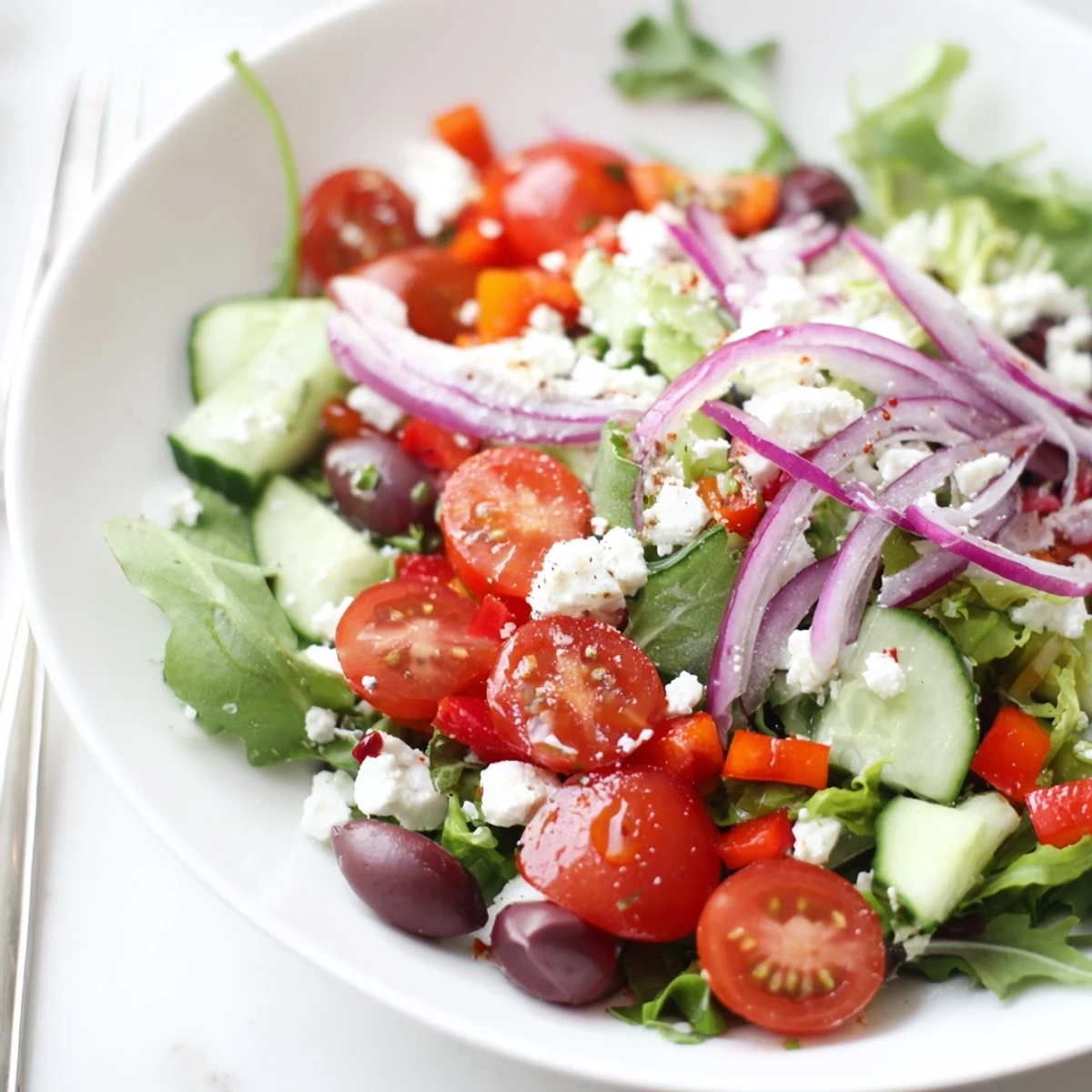 Colorful Fresh Salad Recipe featuring arugula, feta crumbles, tangy Dijon honey vinaigrette.