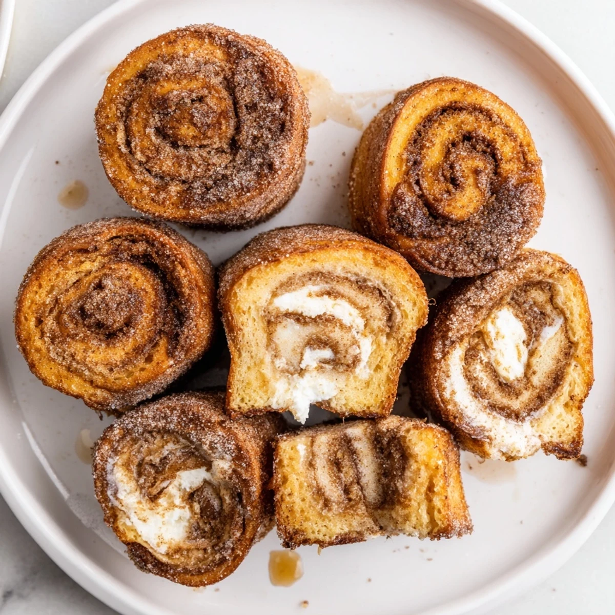Handheld Cinnamon Roll French Toast Roll Ups filled with sweet cream cheese, perfect brunch