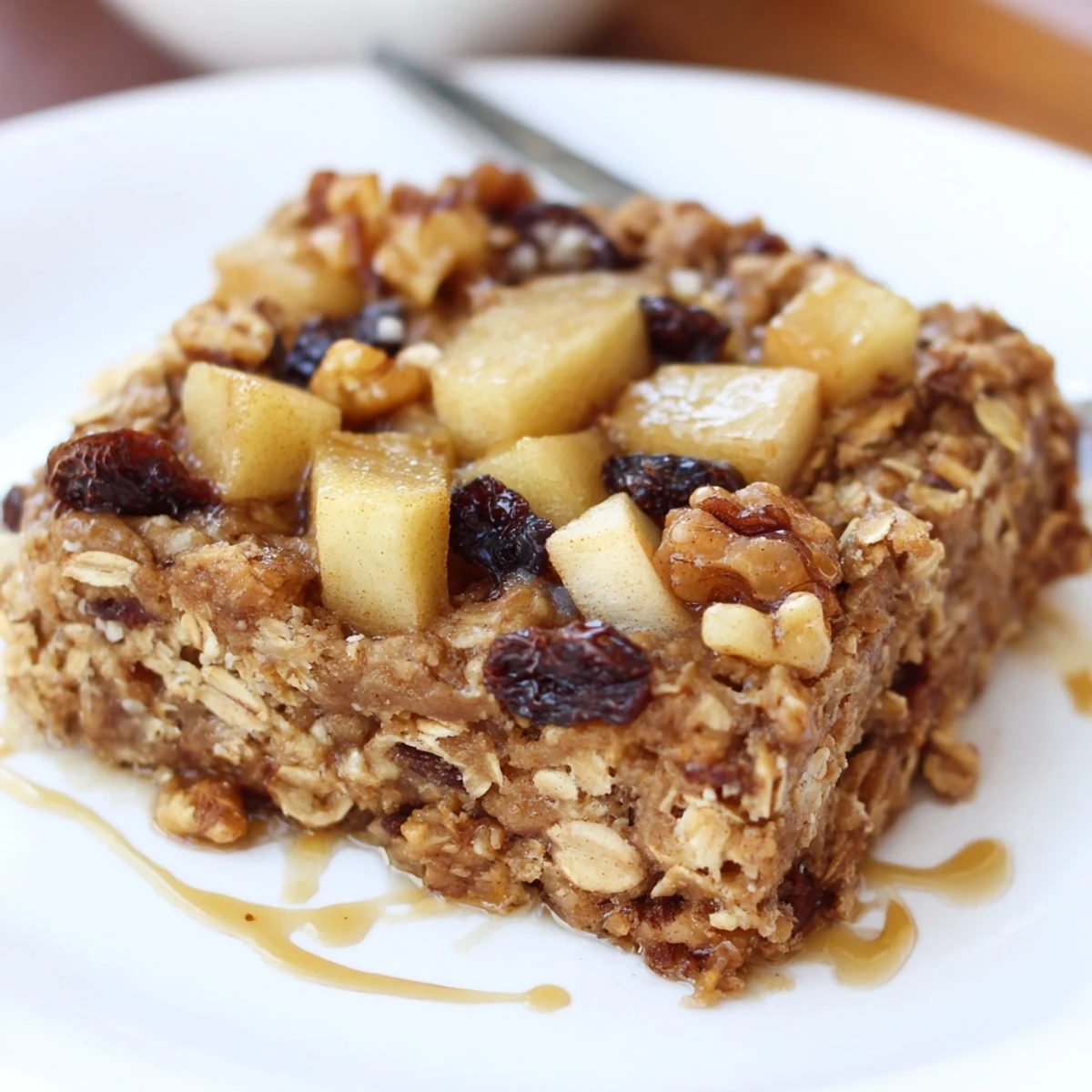 Slice of Delicious Apple Cinnamon Oatmeal Bake Recipe For Mornings topped with walnuts  