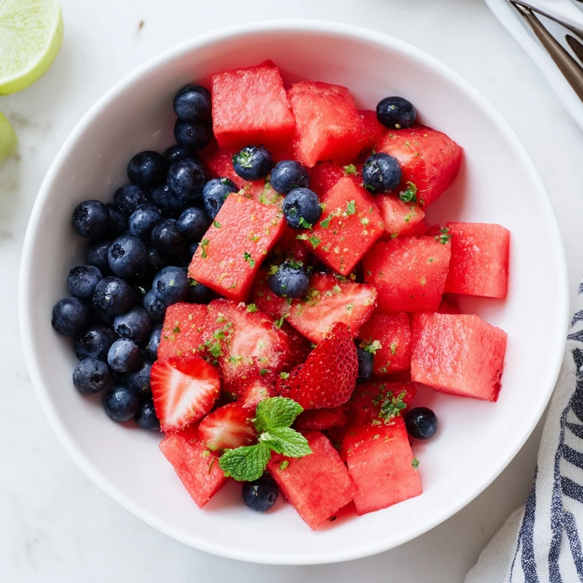 Sweet watermelon delight chilled in glass bowl with fresh mint and citrus dressing