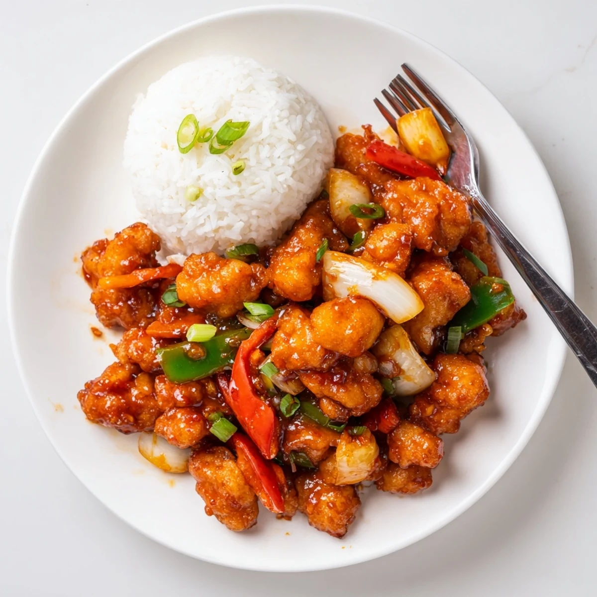 Flavorful Chilli Chicken Indo Chinese glazed, crispy bites with bell peppers and scallions.