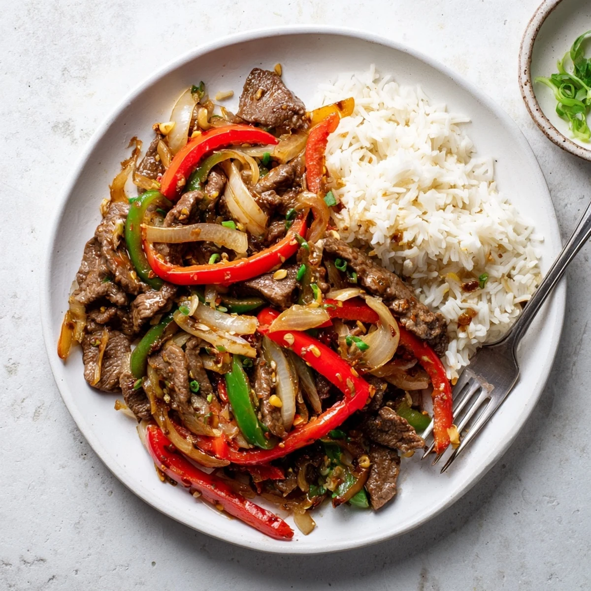 Tender sliced beef and crisp colorful bell peppers tossed in a fiery chili garlic glaze