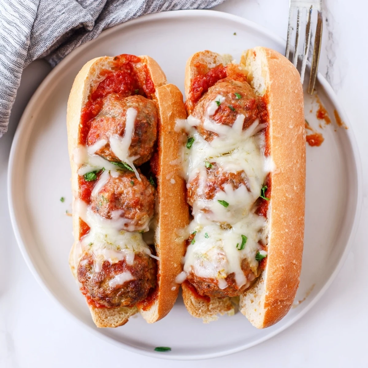 Savory homemade meatballs simmered in rich sauce inside crispy hoagie rolls with melted cheese