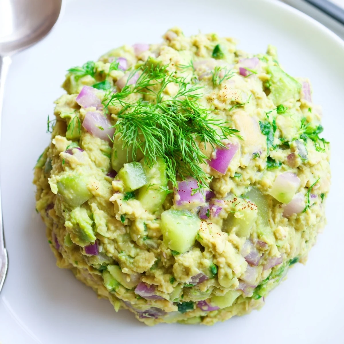 Bright Smashed Chickpea Avocado Pickle in bowl, zesty lemon and herbs