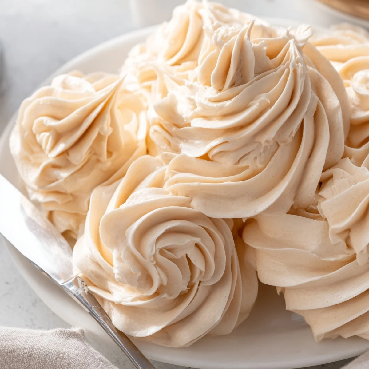 Creamy Italian meringue buttercream swirled atop a golden layer cake